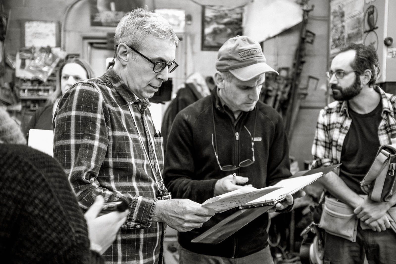 A black-and-white photo of Aaron Weisblatt working on a film set