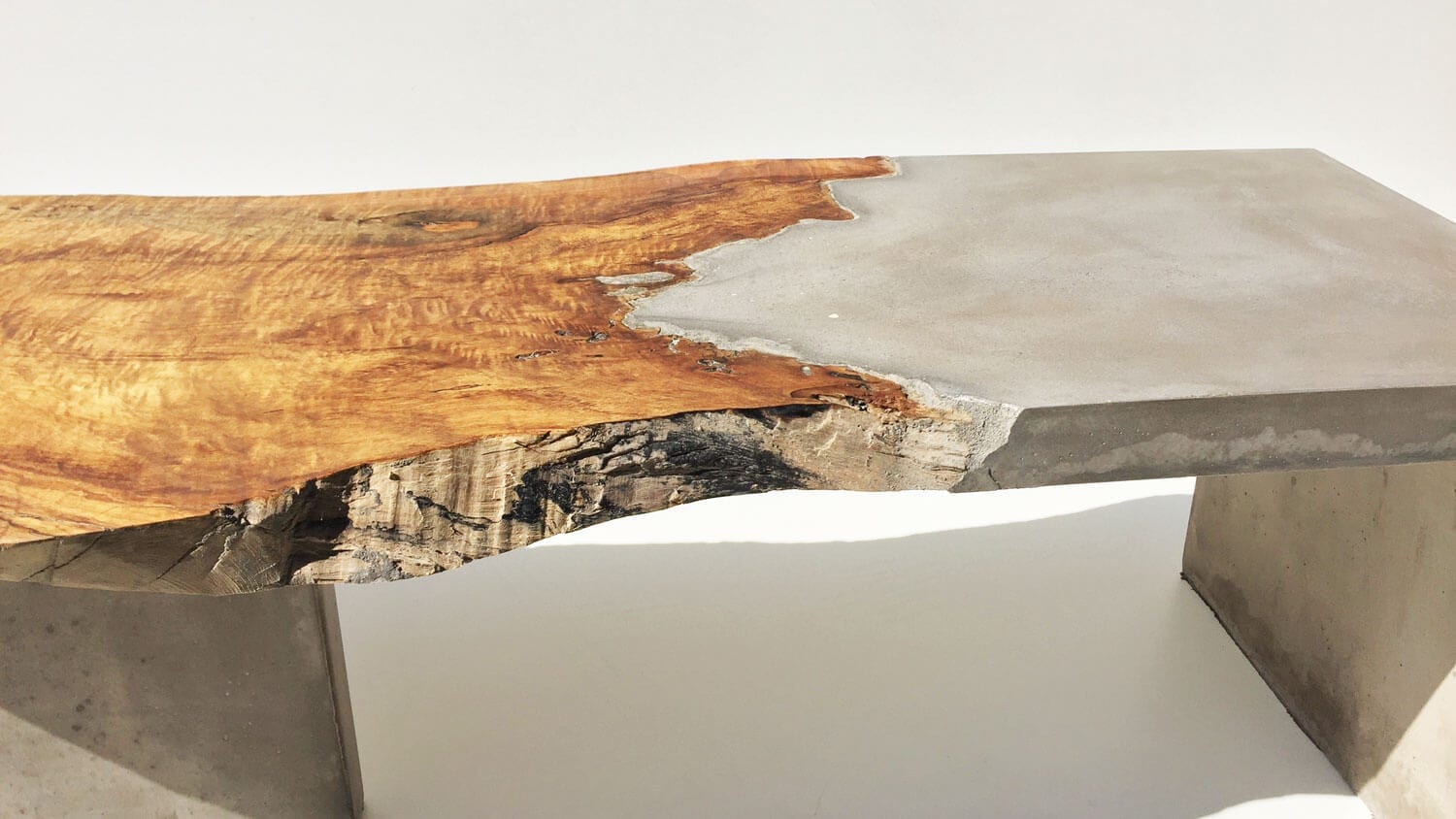 A detail picture of the seams between the concrete and driftwood in a Brad Teasdale mermaid bench