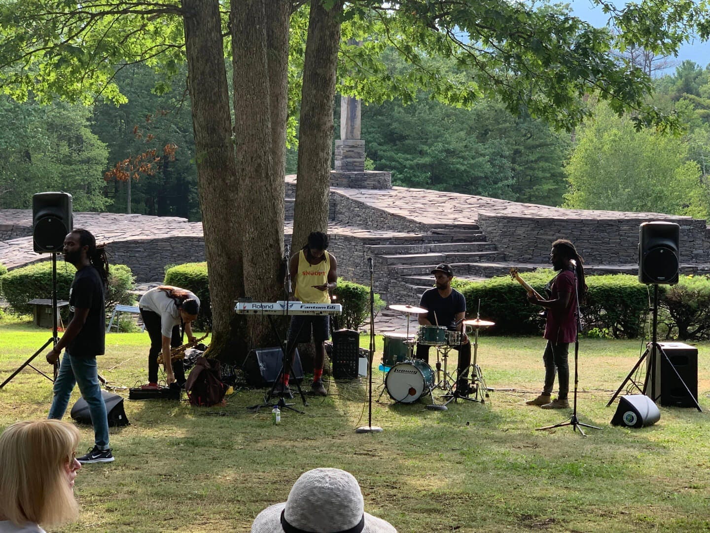 Musicians performing in front of the sculpture at Opus 40