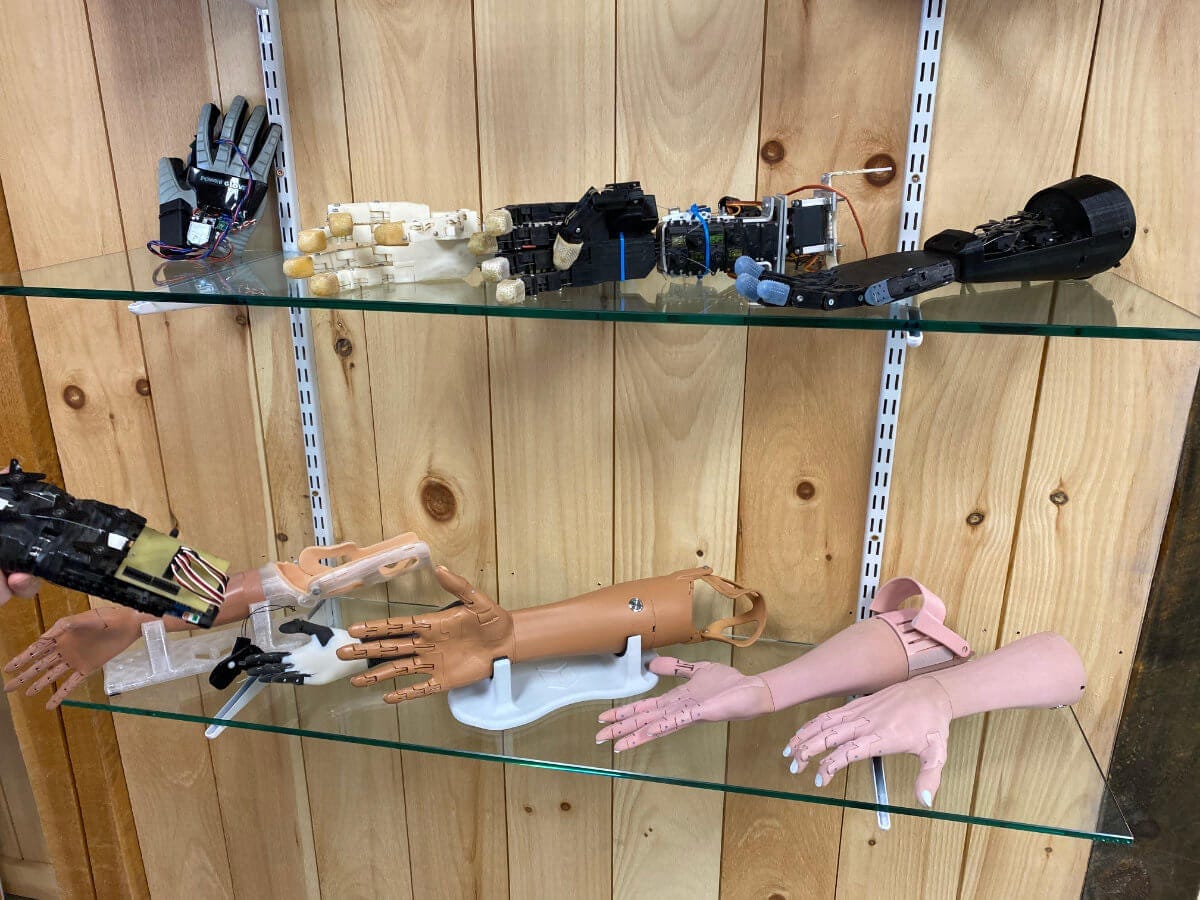 Several generations of the Unlimited Tomorrow prosthetic hand on display at their office