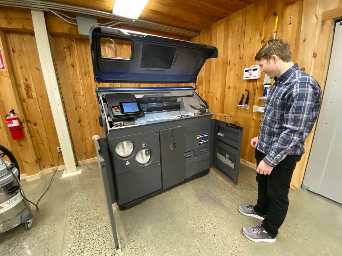 Easton LaChappelle with one of the industrial-grade 3D printers at the Unlimited Tomorrow office in Rhinebeck NY