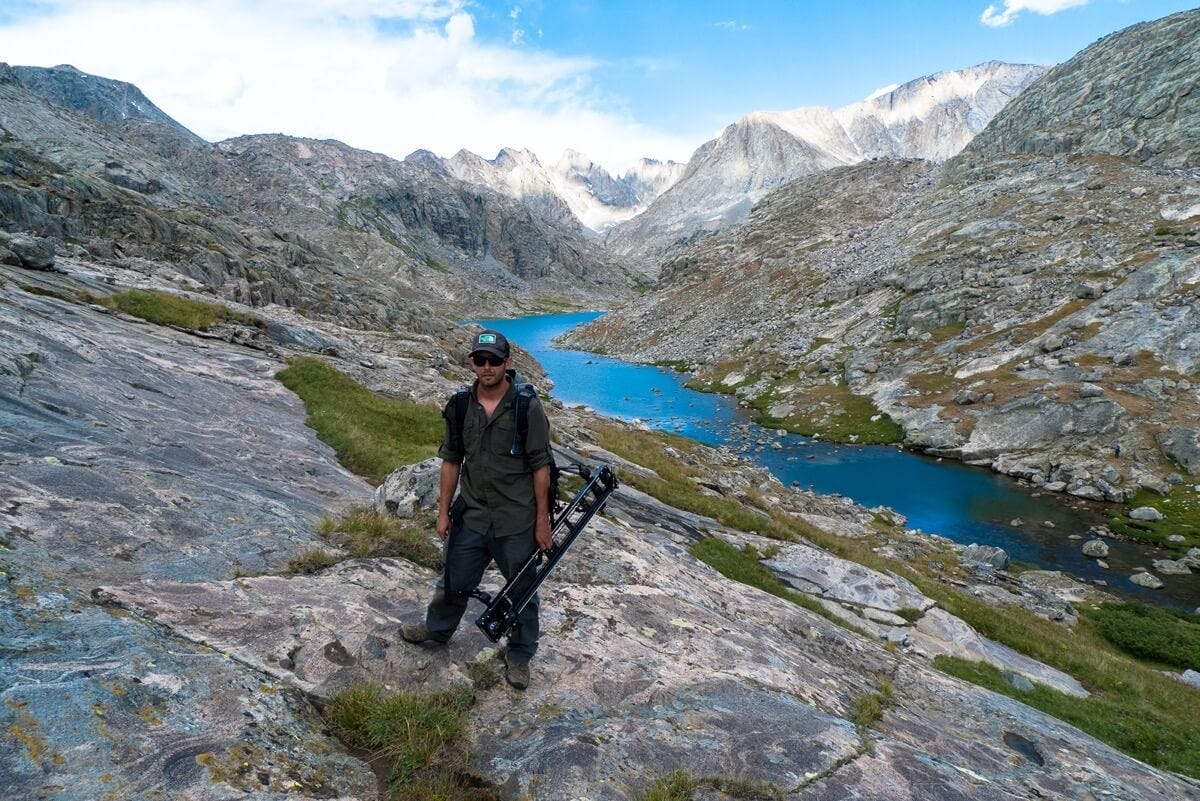 Jesse Brown holding a tripod in Wyoming