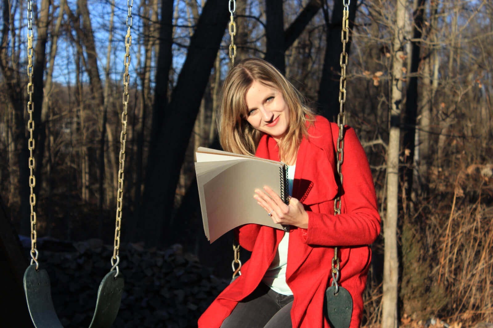 Hudson Valley-based illustrator Julia Green sitting on a swing
