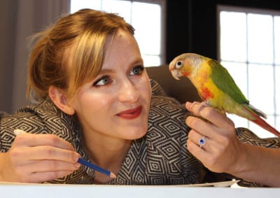 Julia Green and her pineapple conure, Pebbles