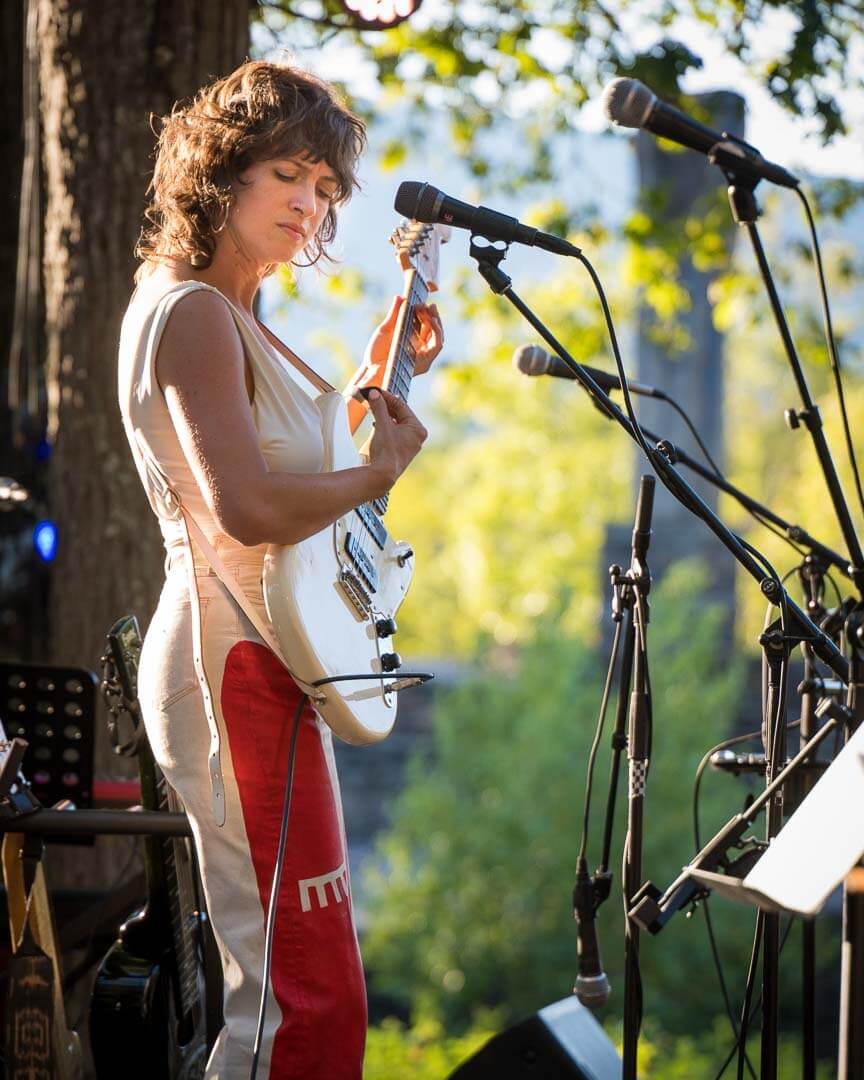 Kendra McKinley playing guitar at the Rock the Quarry concert at Opus 40